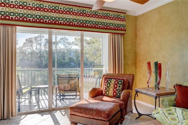 sitting room featuring crown molding, ceiling fan, and light tile patterned floors