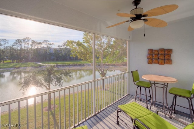 sunroom / solarium featuring a healthy amount of sunlight and a water view