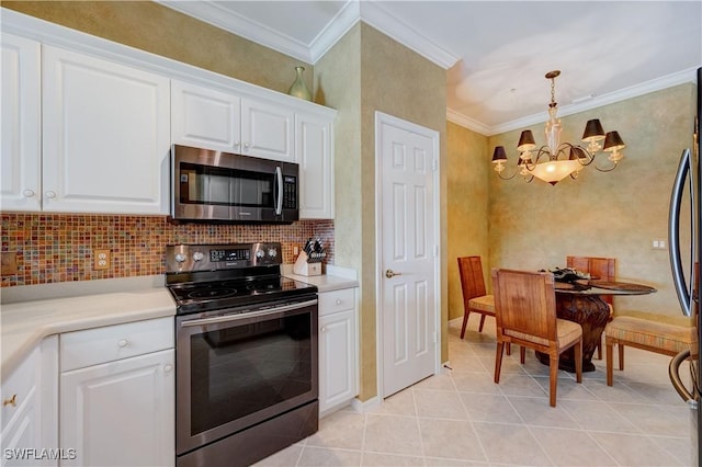 kitchen featuring appliances with stainless steel finishes, white cabinets, backsplash, hanging light fixtures, and ornamental molding