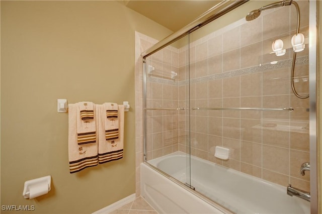 bathroom with tile patterned floors and shower / bath combination with glass door