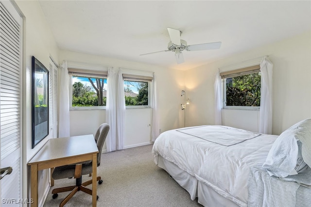 bedroom featuring ceiling fan and light carpet