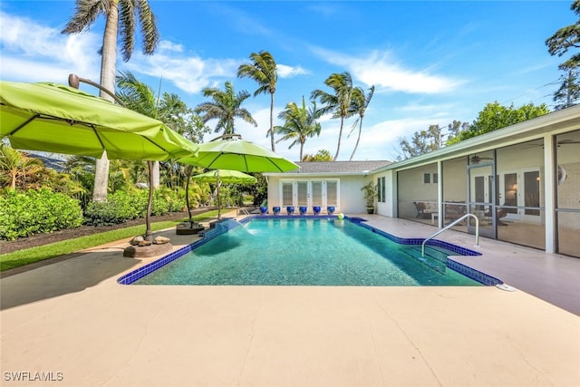 view of pool featuring a patio area and french doors