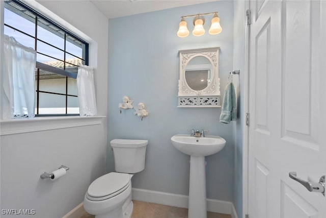 bathroom with tile patterned floors, toilet, and sink