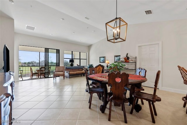 dining space featuring light tile patterned floors and a chandelier