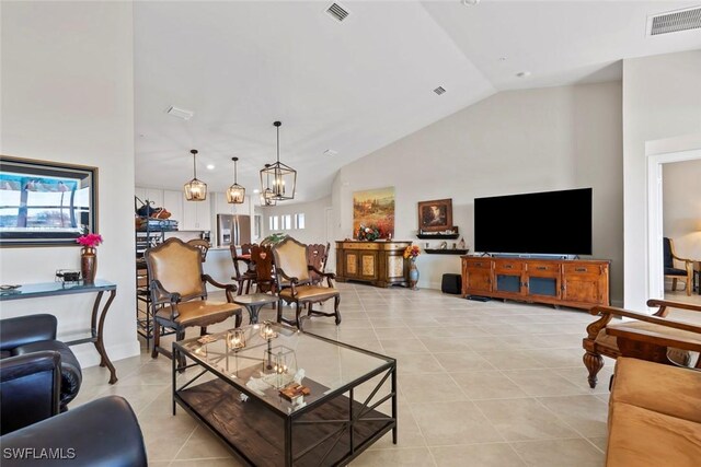 living room featuring a notable chandelier, high vaulted ceiling, and light tile patterned floors