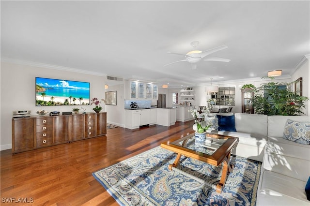 living room featuring crown molding, dark hardwood / wood-style floors, and ceiling fan