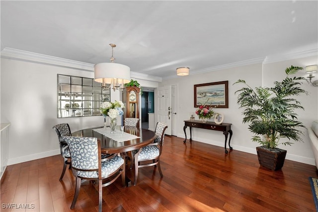 dining room with crown molding, dark hardwood / wood-style flooring, and a notable chandelier