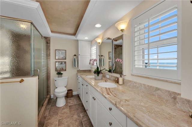 bathroom with a tray ceiling, vanity, walk in shower, toilet, and a water view