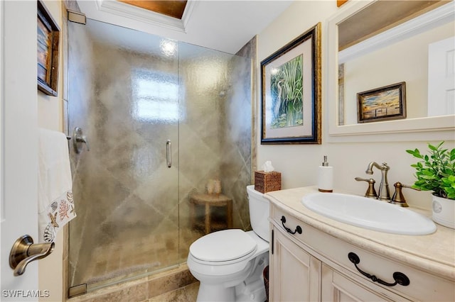 bathroom featuring crown molding, vanity, toilet, and a shower with door