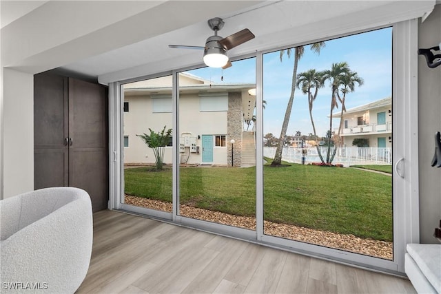 doorway to outside featuring ceiling fan and light wood-type flooring