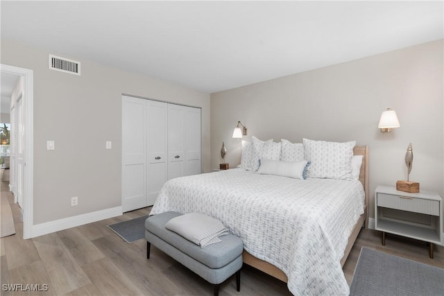 bedroom with wood-type flooring and a closet