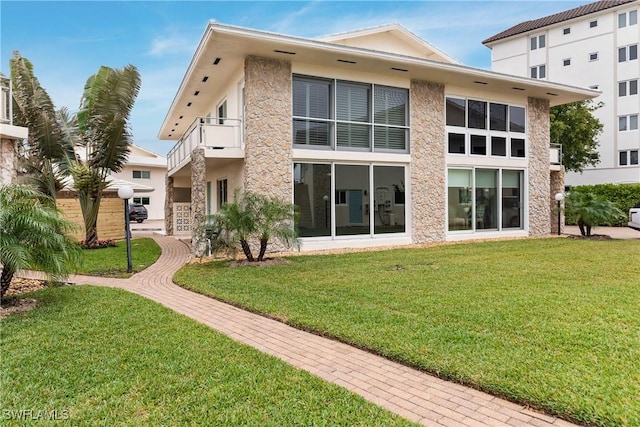 rear view of property with a lawn