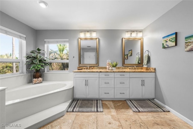 bathroom featuring vanity and a washtub