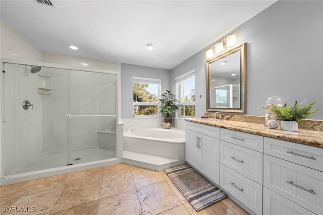 bathroom featuring vanity and separate shower and tub