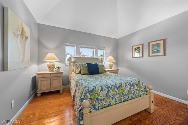 bedroom featuring vaulted ceiling and light hardwood / wood-style flooring