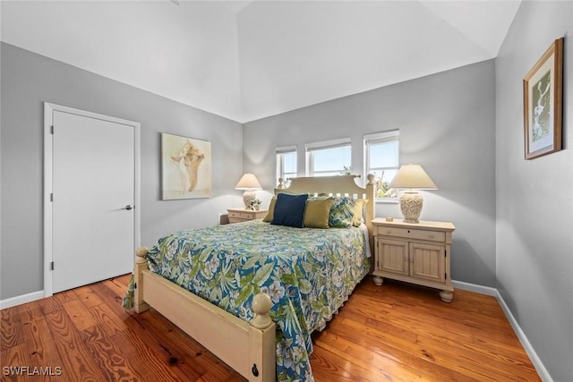 bedroom featuring vaulted ceiling and light hardwood / wood-style flooring