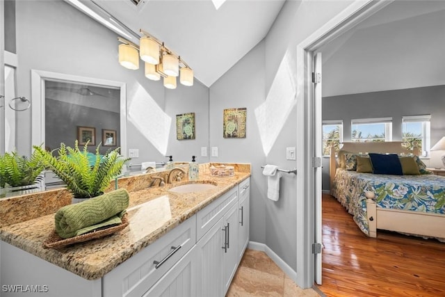 bathroom featuring vanity and vaulted ceiling