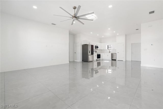 unfurnished living room with ceiling fan