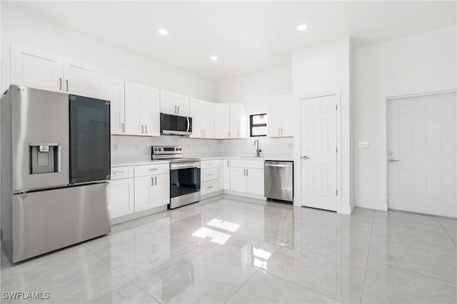 kitchen featuring white cabinetry, appliances with stainless steel finishes, and sink