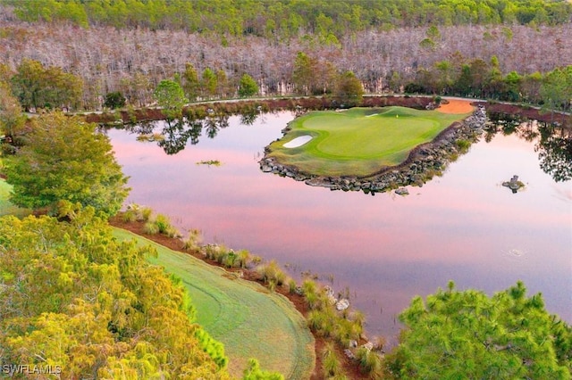 aerial view at dusk featuring a water view