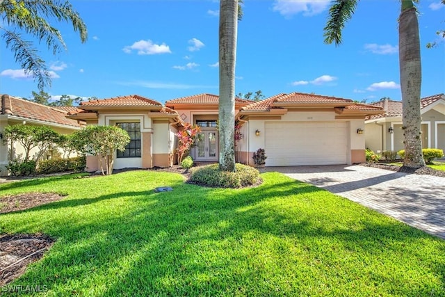 mediterranean / spanish-style home featuring a garage and a front lawn