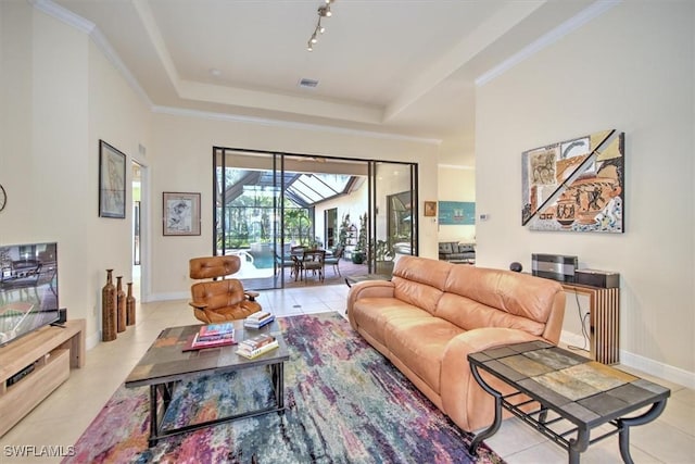 living room featuring crown molding, a tray ceiling, and light tile patterned flooring