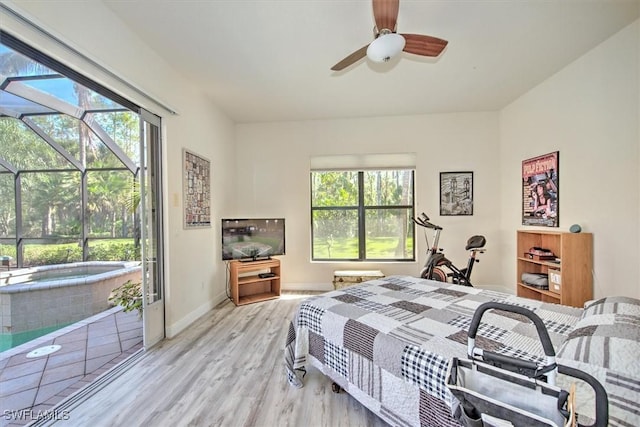 bedroom with multiple windows, access to exterior, light hardwood / wood-style floors, and ceiling fan