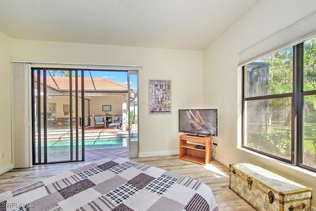 unfurnished bedroom featuring light hardwood / wood-style flooring and access to outside