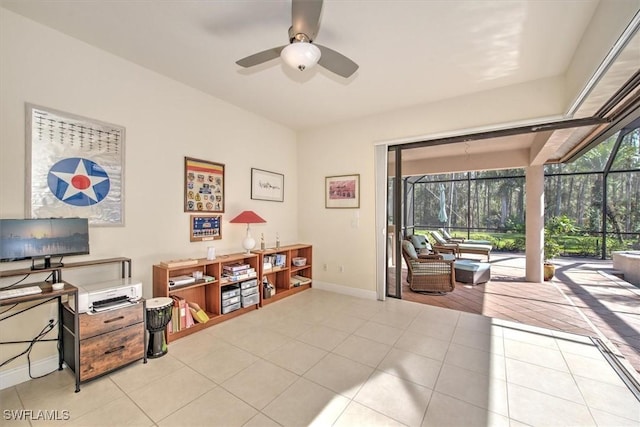 interior space with light tile patterned flooring, a wealth of natural light, and ceiling fan