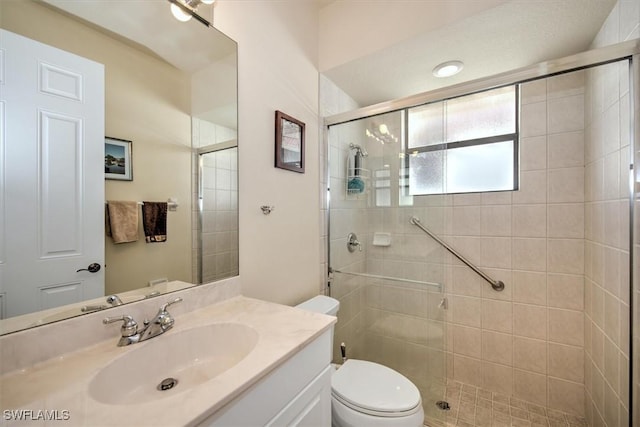 bathroom with vanity, toilet, and walk in shower