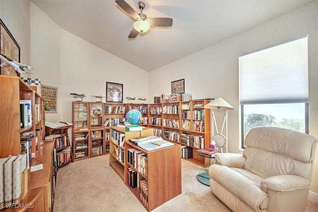 office featuring ceiling fan, vaulted ceiling, and light carpet