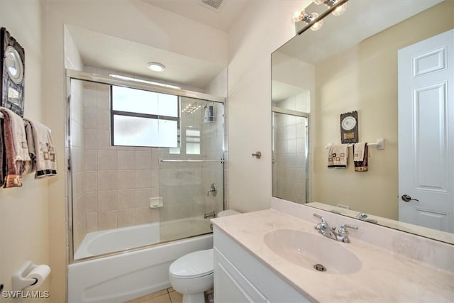 full bathroom with bath / shower combo with glass door, vanity, and toilet