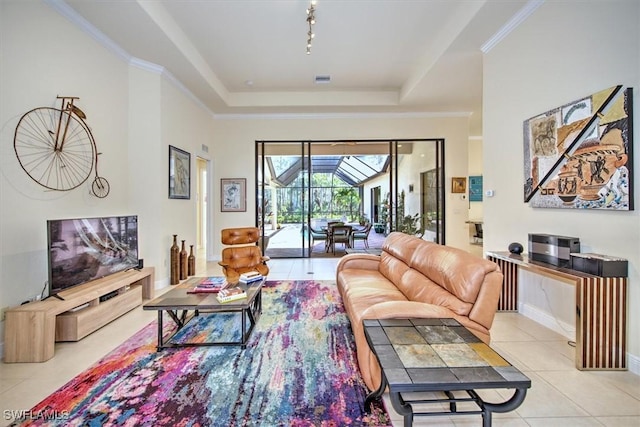 tiled living room featuring crown molding, a tray ceiling, and rail lighting