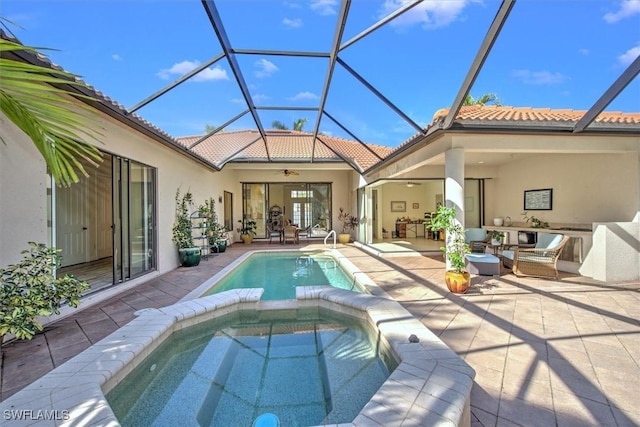 rear view of property with ceiling fan, glass enclosure, a pool with hot tub, and a patio area