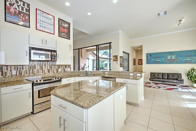 kitchen with white cabinetry, a center island, light tile patterned floors, kitchen peninsula, and stainless steel appliances