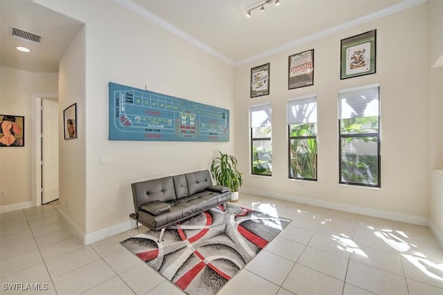 interior space with crown molding, light tile patterned floors, and track lighting