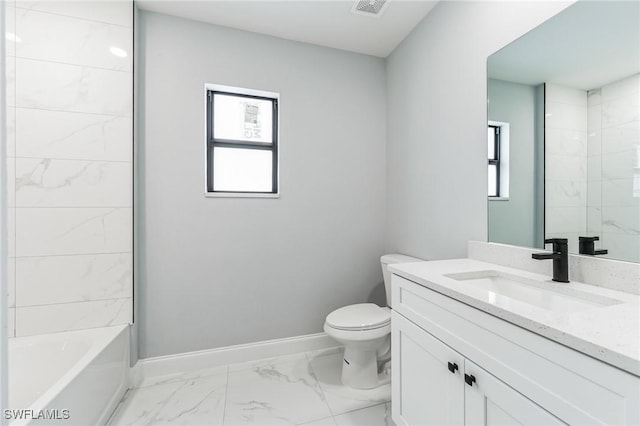 full bathroom featuring vanity, tiled shower / bath, a wealth of natural light, and toilet