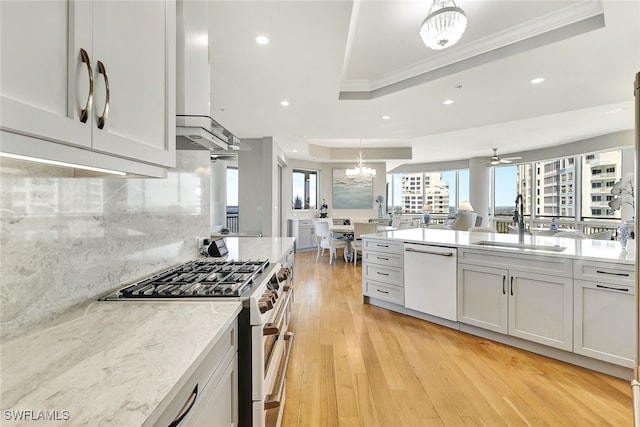 4931 Bonita Bay Blvd Unit 2103, Bonita Springs, FL 34134 - kitchen featuring dishwasher, gas range oven, a sink, ornamental molding, and a raised ceiling