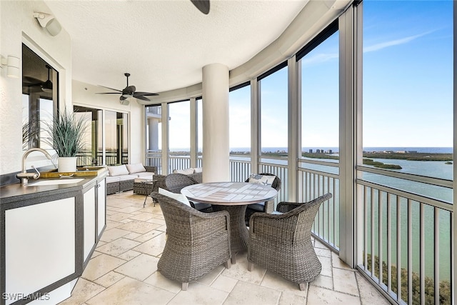4931 Bonita Bay Blvd Unit 2103, Bonita Springs, FL 34134 - sunroom / solarium featuring stone tile flooring, ceiling fan, a water view, a sink, and a textured ceiling