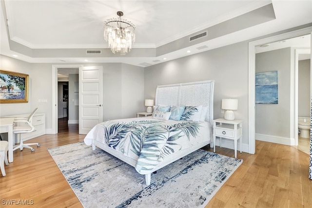 bedroom featuring an inviting chandelier, wood-type flooring, crown molding, and a raised ceiling