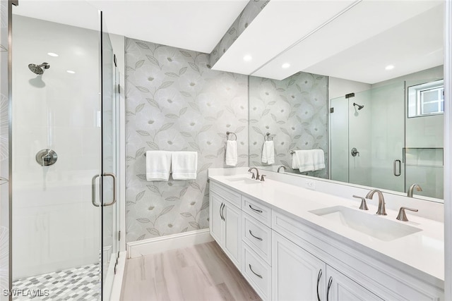 4931 Bonita Bay Blvd Unit 2103, Bonita Springs, FL 34134 - bathroom featuring a shower stall, baseboards, double vanity, recessed lighting, and wallpapered walls