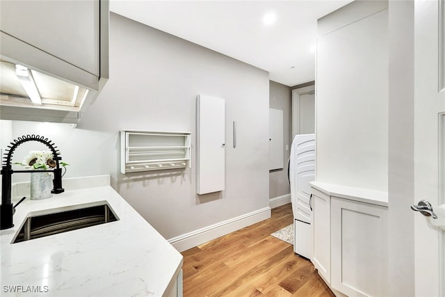 4931 Bonita Bay Blvd Unit 2103, Bonita Springs, FL 34134 - bathroom with a sink, baseboards, and wood finished floors
