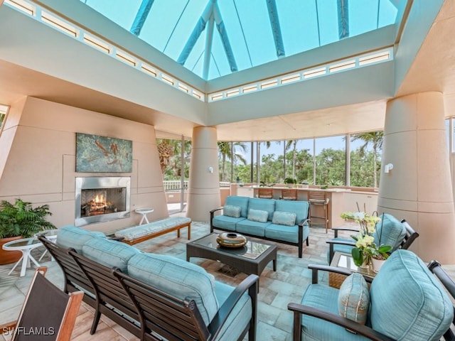 view of patio featuring an outdoor living space with a fireplace