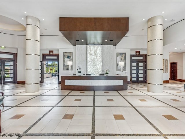 reception area featuring french doors and ornate columns