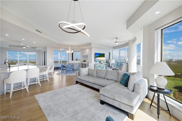 4931 Bonita Bay Blvd Unit 2103, Bonita Springs, FL 34134 - living room featuring a chandelier, light wood finished floors, recessed lighting, and a ceiling fan
