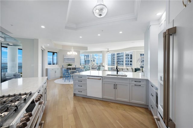 4931 Bonita Bay Blvd Unit 2103, Bonita Springs, FL 34134 - kitchen with high quality appliances, a tray ceiling, a sink, open floor plan, and crown molding