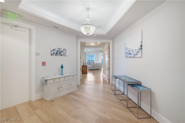4931 Bonita Bay Blvd Unit 2103, Bonita Springs, FL 34134 - hallway featuring ornamental molding, light wood-type flooring, a raised ceiling, a chandelier, and baseboards