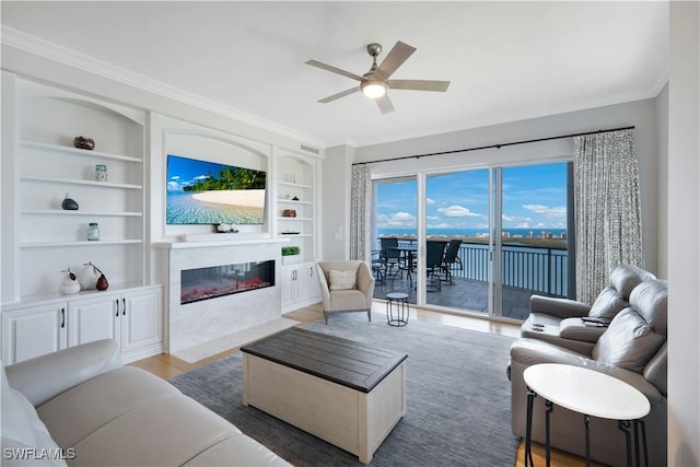 4931 Bonita Bay Blvd Unit 2103, Bonita Springs, FL 34134 - living room featuring a fireplace with flush hearth, ceiling fan, built in features, wood finished floors, and crown molding