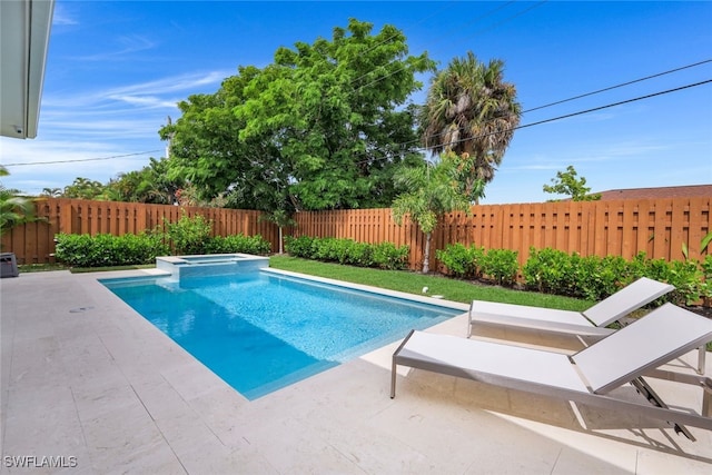 view of pool featuring a patio and an in ground hot tub