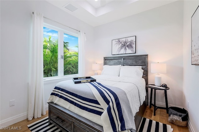 bedroom featuring multiple windows and light wood-type flooring